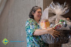 Classified staff with basket at End of Year Luau