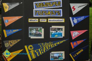 Transfer Tuesdays display boards with pennants from different colleges.