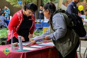 Students looking over information at 2017 Transfer Fair.