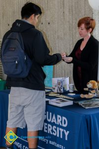 Vanguard University representative assisting a student at the 2017 Transfer Fair.