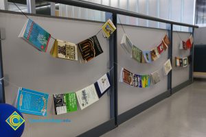 Books hanging on string