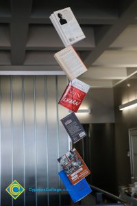 Books hanging from the ceiling by string