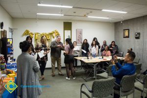 Psi Beta Members of a graduating Psychology class light candles.