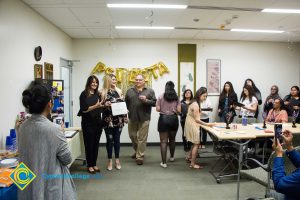 Psi Beta Members of a graduating Psychology class pose for a photo with an award.