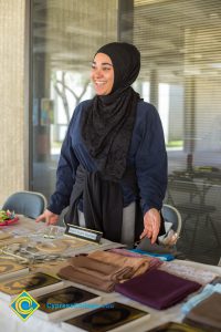 A woman wearing a hijab at a booth for Muslim & Native American Awareness Day.