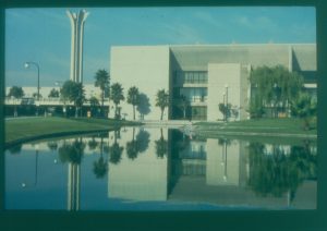 View of the pond with the Complex and campanile in the background and reflected on the water.