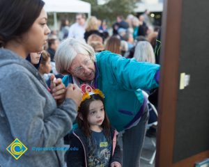 Women and child looking at display at the 2016 Yom HaShoah event,