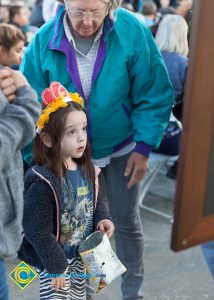 Child looking at a display at the Yom HaShoah event.