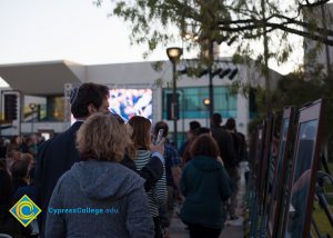 Crowd of people looking at the 2016 Yom HaShoah photo displays.