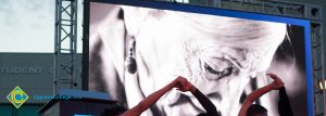 Image of a Holocaust survivor on the big screen.