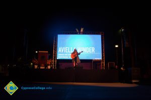 Aviella Winder playing guitar at the 2016 Yom HaShoah event.