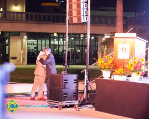 Clifford Lester hugging President Bob Simpson as he welcomes him on stage.