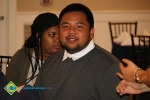 Male student wearing gray sweater and white button-down shirt