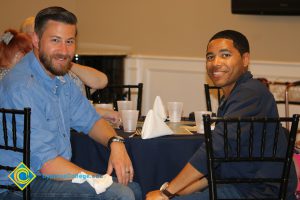 Rick Rams and Wes McCurtis sitting together at a table at the Associated Students Banquet
