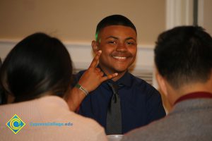 Male student giving the hang ten sign