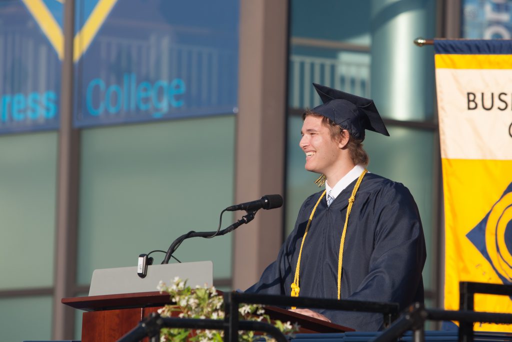 Graduate speaking at commencement.