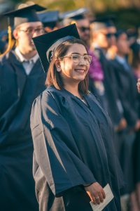 Graduate smiling during commencement.