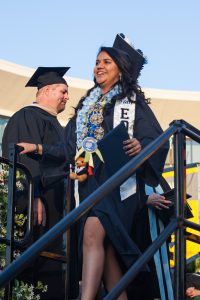 Graduate holding diploma.