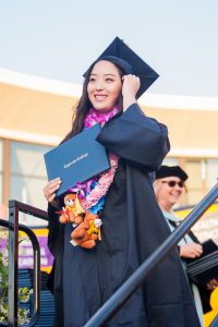 Graduate holding diploma.