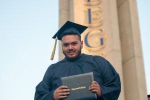 Graduate holding diploma.