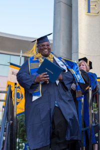 Male student who just received his degree smiling