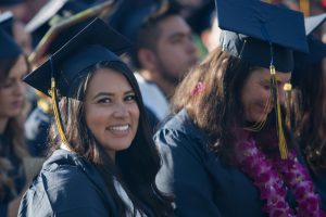 Smiling graduates during commencement.