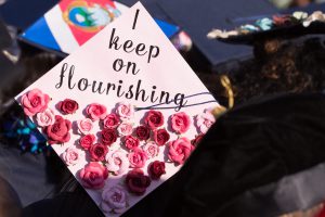 Graduation cap with roses and "I keep on flourishing."