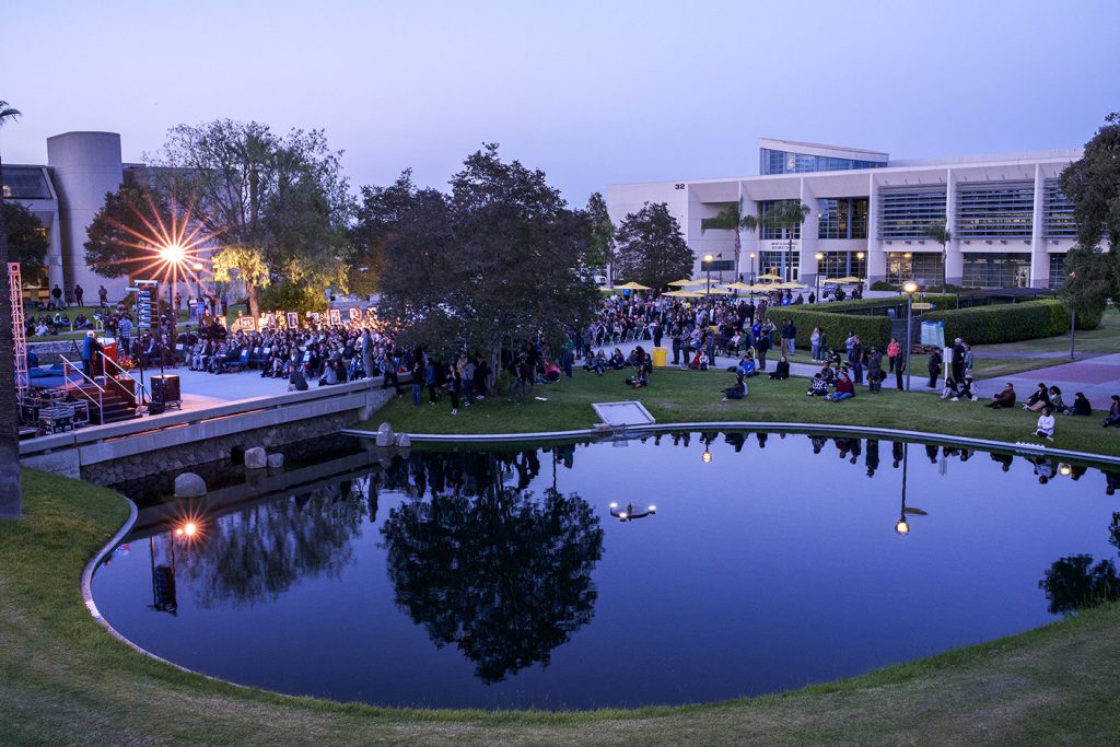 People gathered around the pond