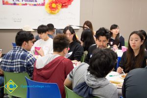 Students eating at the ESL potluck.