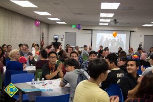 Students eating at the ESL potluck.