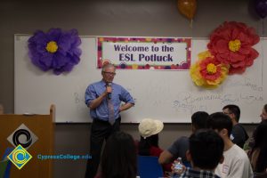 Bob Simpson addressing staff and students at the ESL potluck.
