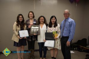 President Bob Simpson standing with awardees at the 2017 ESL potluck.