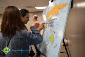 Students looking at a world map.