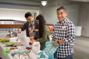 Students at the food table at the ESL potluck.