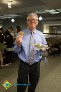 President Bob Simpson smiling with a plate of food.