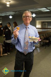 President Bob Simpson smiling with a plate of food.
