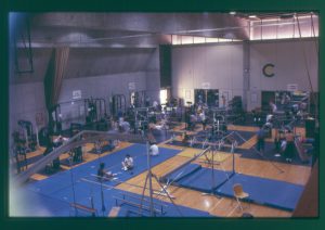 Aerial view of the inside of the gym with students working out on exercise equipment.