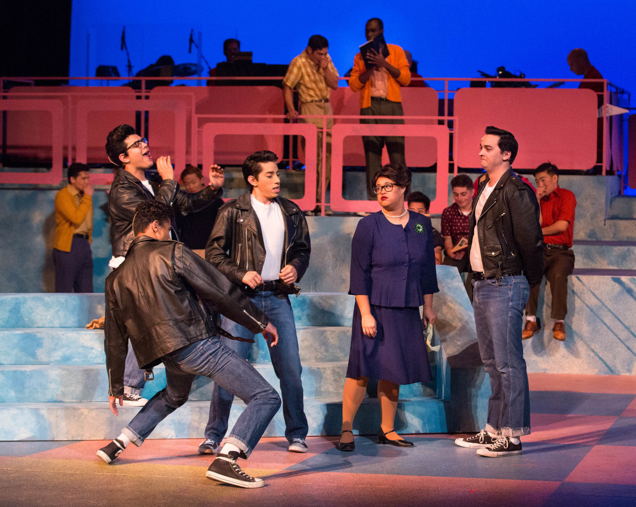 Theater students performing a scene from Grease.