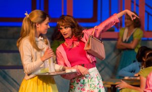 Two women performing in Grease production.