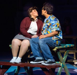 Theater students performing a scene from Grease.