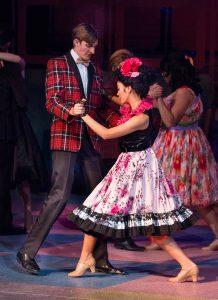 Theater students performing a scene from Grease.