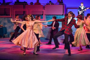 Theater students performing a scene from Grease.