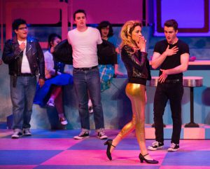 Students performing a scene from Grease.