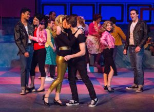 Theater students performing a scene from Grease.