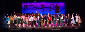 Theater students performing a scene from Grease.