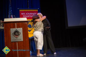 Dr. Therese Mosqueda-Ponce hugs Dr. Schilling at Fall Opening Day.