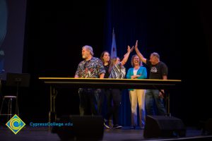 Staff congratulating each other during Family Feud game at Fall Opening Day.