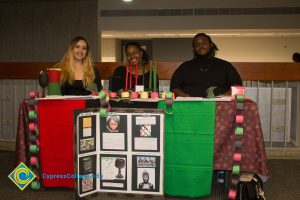 Students sitting at the Kwanzaa table.