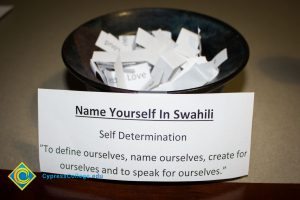 Bowl of words with sign that reads "Name Yourself In Swahili"