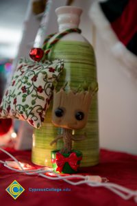 Christmas bottle with fabric pillow hanging from it.